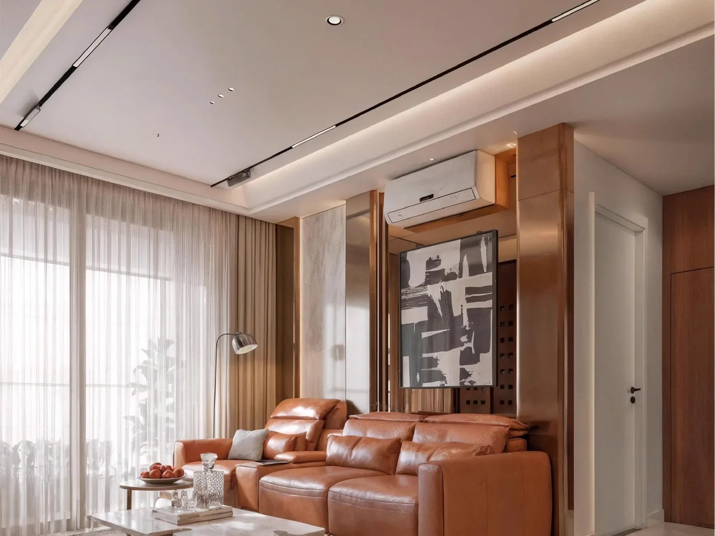 A bright apartment living room with a cognac leather sofa, linear ceiling lights and sheer curtains.