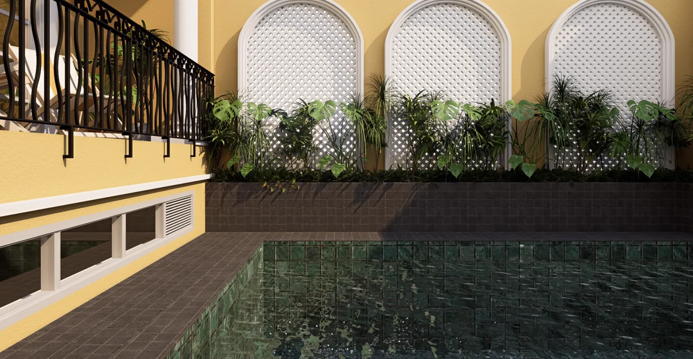 A green-tiled pool beside a yellow wall with white lattice arches and hanging plants.